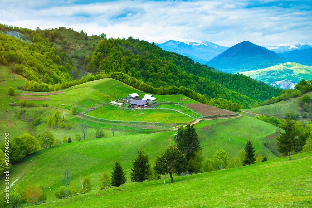 Beautiful simple landscape with sheepfold and house on the hills in rural Romania
