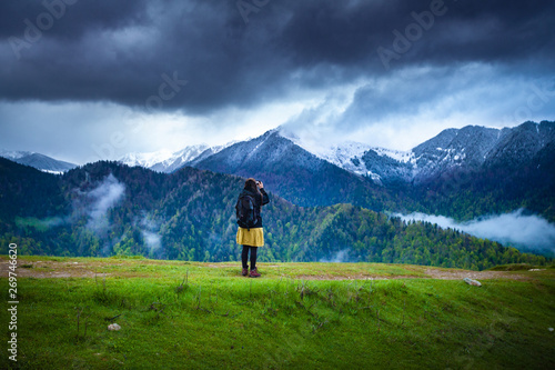 Girl travelling through beautiful epic mountain landscape