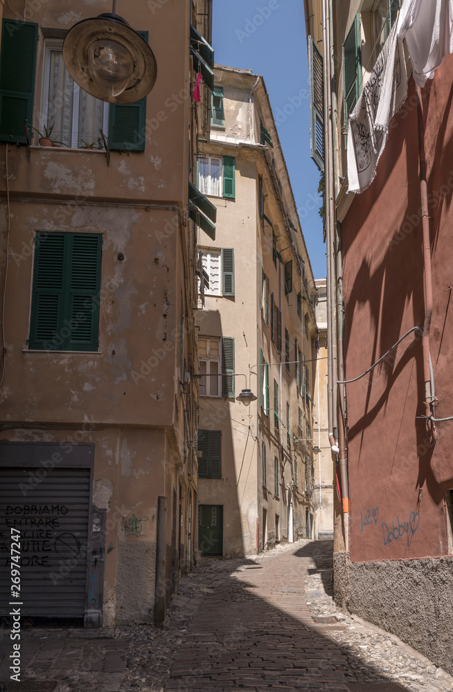 high buildings and narrow alley  in sea town historical center, Genova, Italy