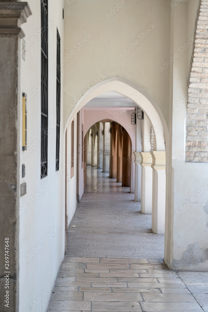 narrow arched covered walkway, Portogruaro , Italy