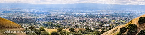 Panoramic view of San Jose  part of Silicon Valley  golden hills and residential areas visible in the foreground  the downtown area visible in the background  South San Francisco bay area  California