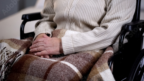 Senior disabled woman covered with blanket closeup  nursing home  retirement