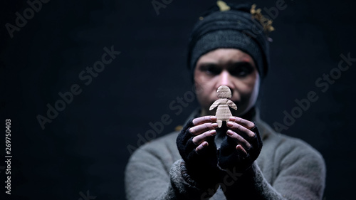 Alcohol addicted homeless showing paper child figure, missing family, loneliness