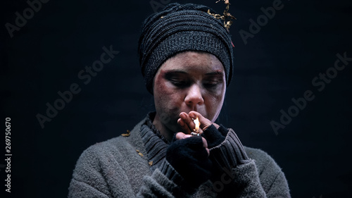 Female bum lighting cigarette, living on street, homeless lifestyle, problem