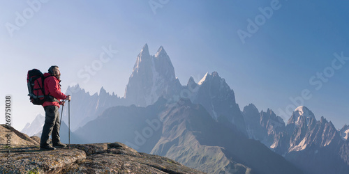 Slika na platnu Mountaineer with backpack on rock