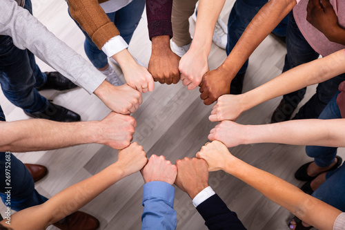 People Hands Joining Their Fist To Form Circle photo