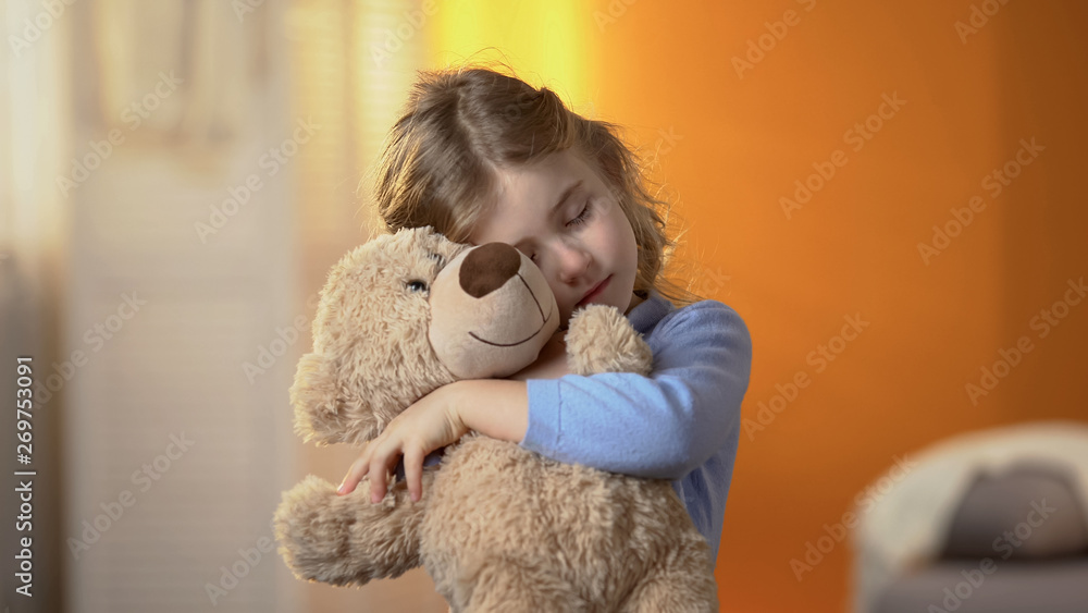 Little lonely girl hugging teddy bear, suffering loneliness, family problems - obrazy, fototapety, plakaty 