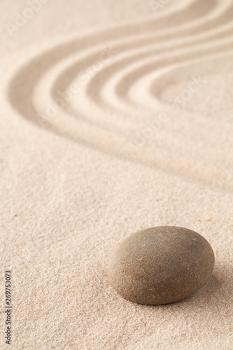 Sand and stone texture background with line pattern. Minimal zen meditation garden. Concept for yoga, spa wellness or buddhism and mindfulness. With copy space..