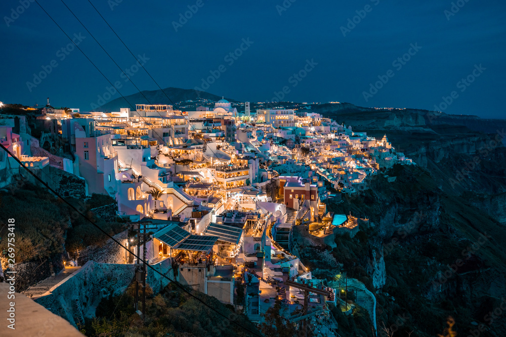 Santorini at Night, one of the most beautiful travel destinations of the world. Panoramic View at the Capital of the island, Fira