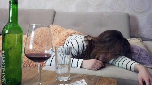 Drunk woman with a headache wakes up after a party, hangover