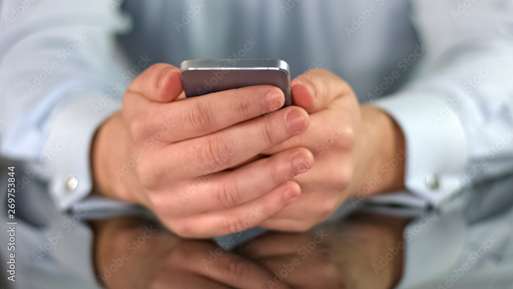 Man holding smartphone in hands closeup reading news, modern technology, app Man holding smartphone in hands closeup reading news, modern technology, app
