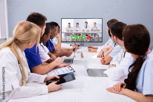 Team Of Professional Doctors Having Video Conference
