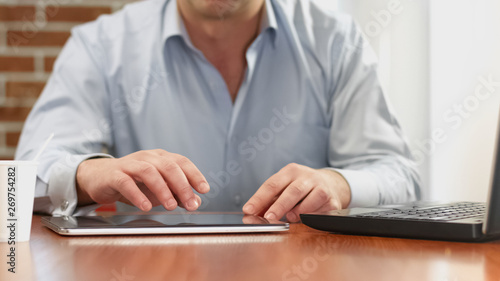 Man browsing internet site tablet  reading news online  preparing presentation