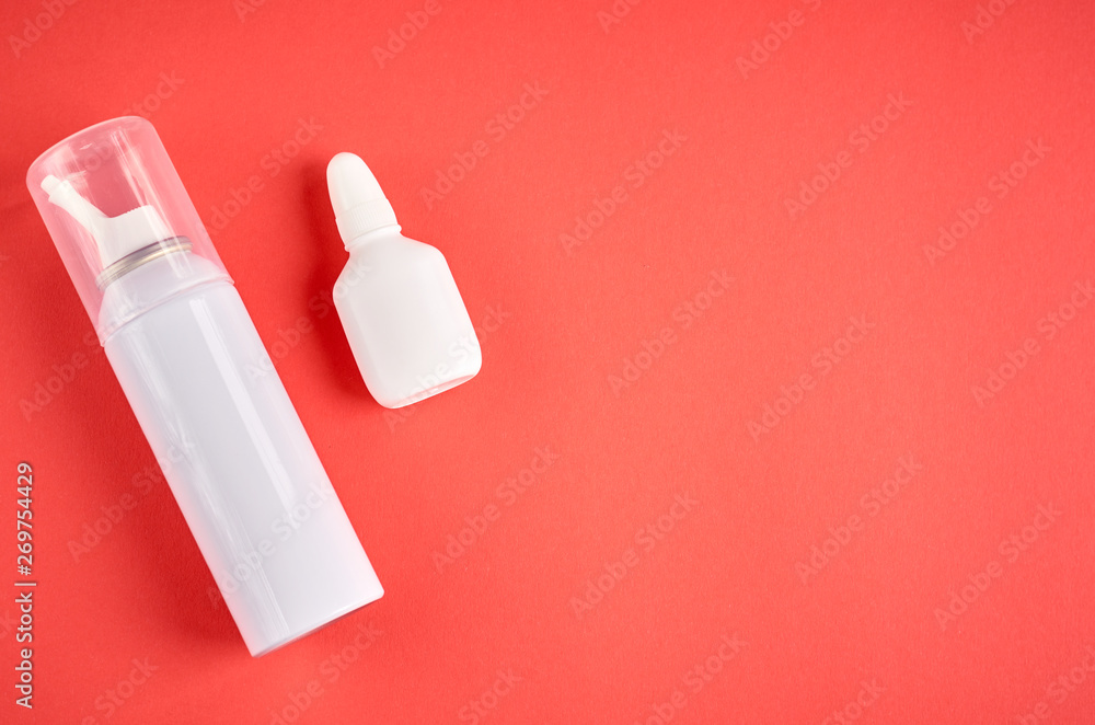 Nasal spray bottle composition, white template bottle on pink background Nasal spray bottle composition, white template bottle on pink background
