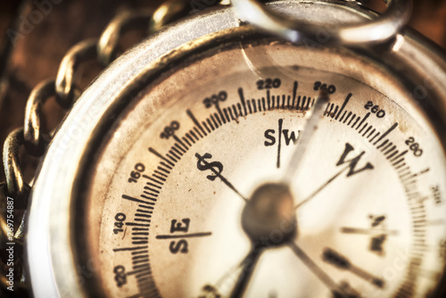 A vintage compass from world war 2 with a silver chain antique rustic mood fine art photography