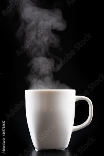 White mug and water vapor. Freshly brewed hot drink.