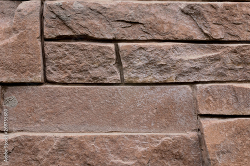 close up of geometric brick stone brown texture background, wall surface facade