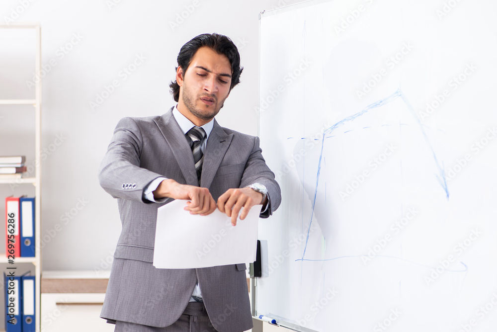 Young handsome businessman in front of whiteboard Young handsome businessman in front of whiteboard