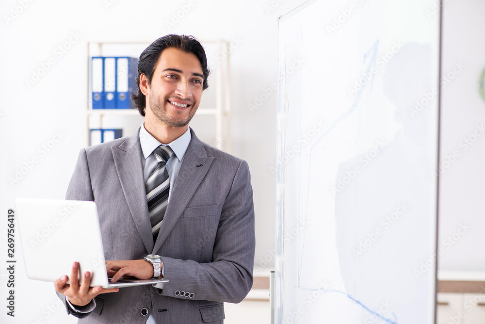Young handsome businessman in front of whiteboard Young handsome businessman in front of whiteboard