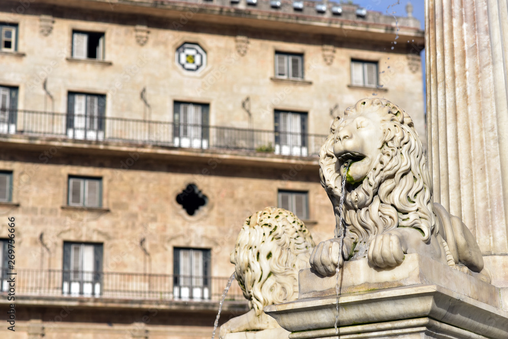 Lion's Fountain (foreground) and Convento San Francisco de Asis at Plaza de San Francisco, Havana old town, Cuba