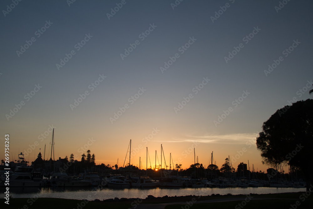 Sunset over a dock in Coronado Bay with sailboats and yachts