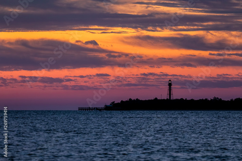 Point Ybel Light at Daybreak - Gorgeous colors fill the sky at daybreak silhouetting the Point Ybel Light, a metal lighthouse on Sanibel Island, Florida.