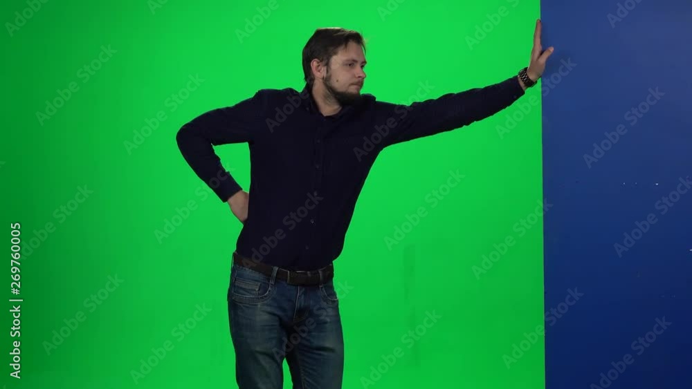 Man leaning hand on wall standing against chroma key background. Man leaning hand on wall standing against chroma key background.