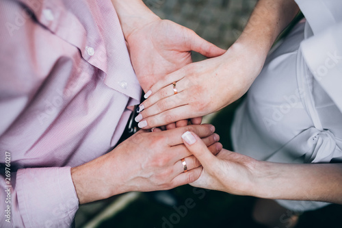 The bride and groom wear wedding rings. hands of newlyweds with wedding rings. Wedding ceremony.
