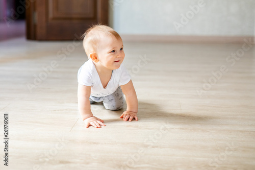 Two babies boy and girl playing chess on the white wooden floor at home