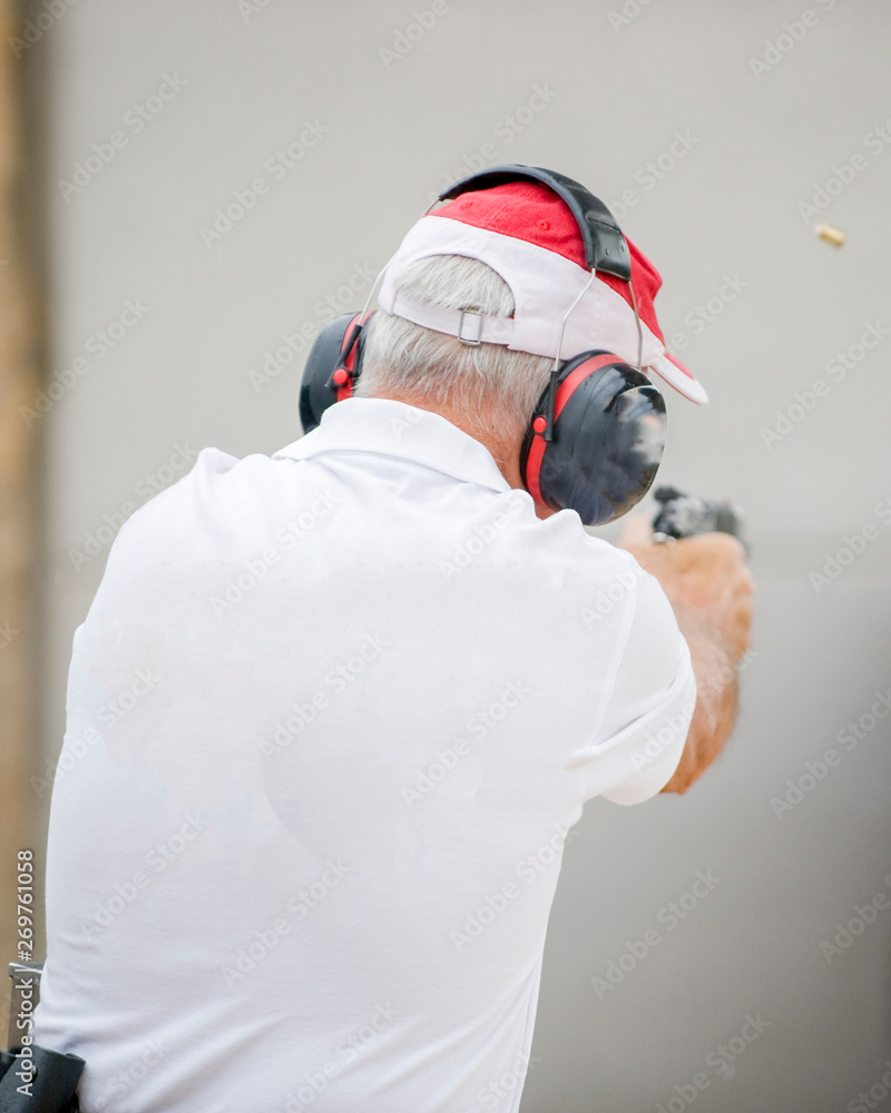 man shooting with the gun at shooting range