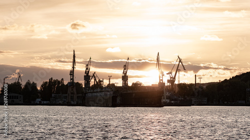 A beautiful view of the shipyard during sunset. Crane and sea