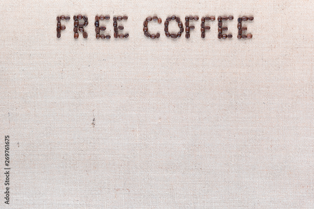 Free coffee words made of coffee beans on linen canvas, arranged top center