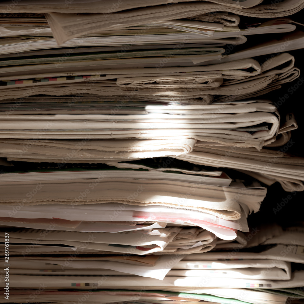Pile of old newspapers and magazines, stack, side view. Vintage background Pile of old newspapers and magazines, stack, side view. Vintage background