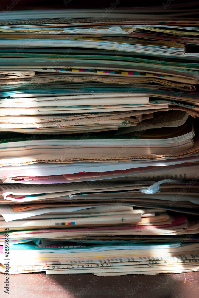 Pile of old newspapers and magazines, stack, side view. Vintage background Pile of old newspapers and magazines, stack, side view. Vintage background