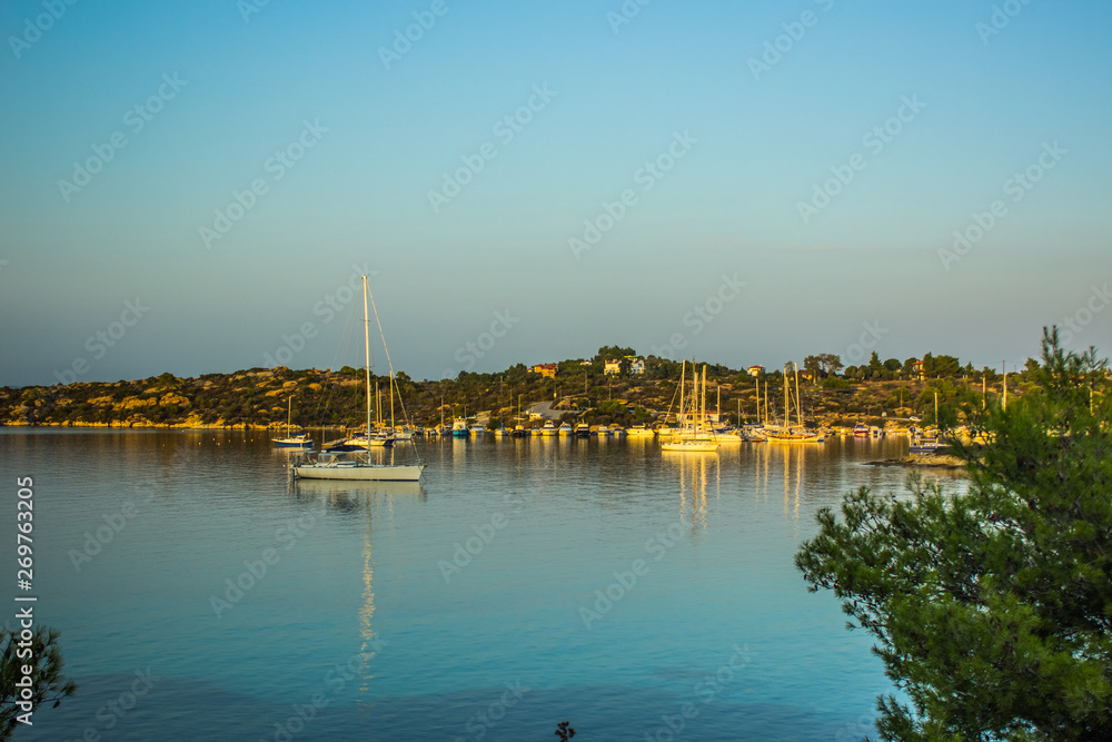 Mediterranean sea lagoon scenic landscape and yachts on calming water surface 