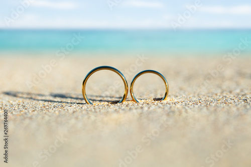Golden And Shiny Wedding Rings On Beach