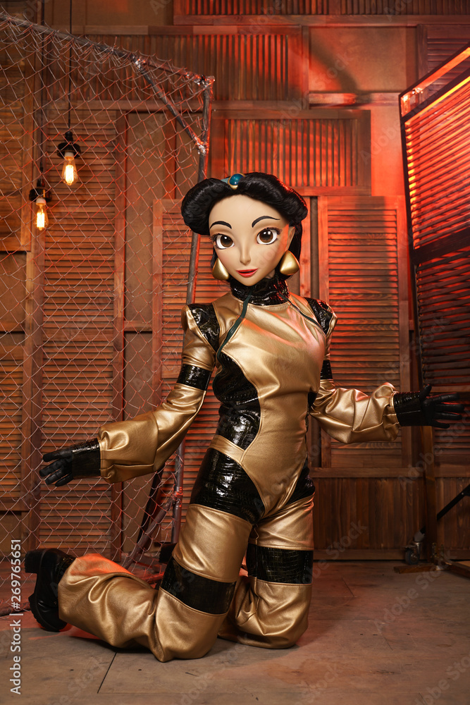 beautiful girl with full face mask doll in leather space jumpsuit posing in her room with light bulbs alone beautiful girl with full face mask doll in leather space jumpsuit posing in her room with light bulbs alone