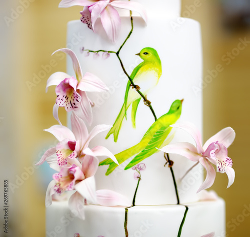 Traditional anniversary/wedding multi-layer cake. Beautiful delicious sweet dessert decorated with flowers