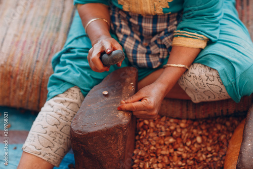 Woman making argan oil by hand craft