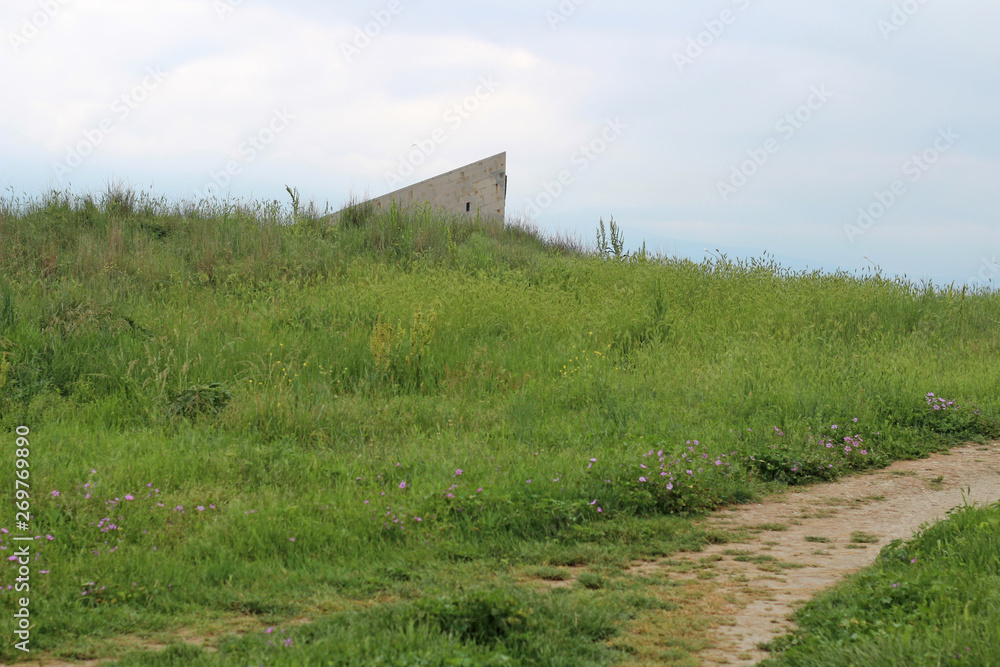 An ancient artifact behind the hill. Monument from the past. Mysterious place. An ancient artifact behind the hill. Monument from the past. Mysterious place.