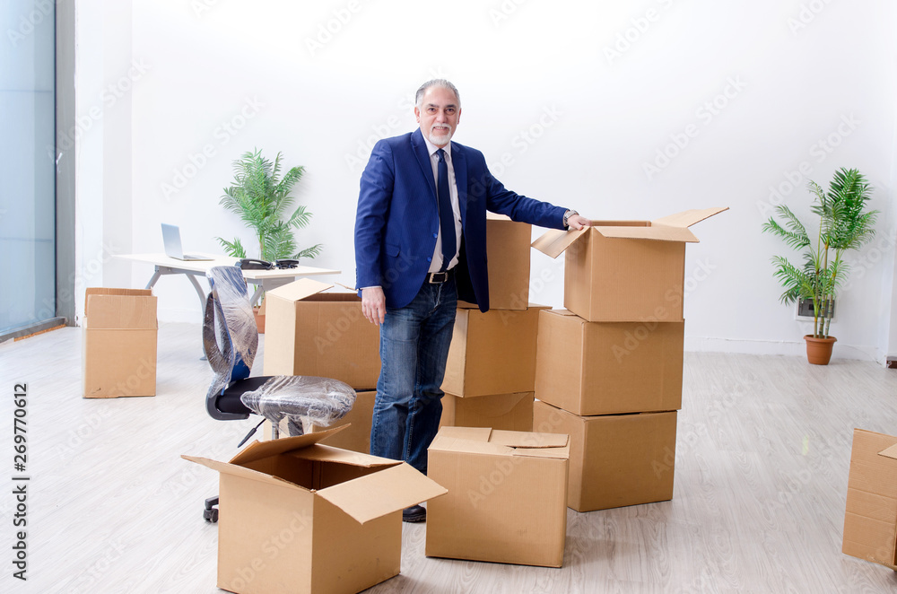 Aged businessman moving to new workplace Aged businessman moving to new workplace