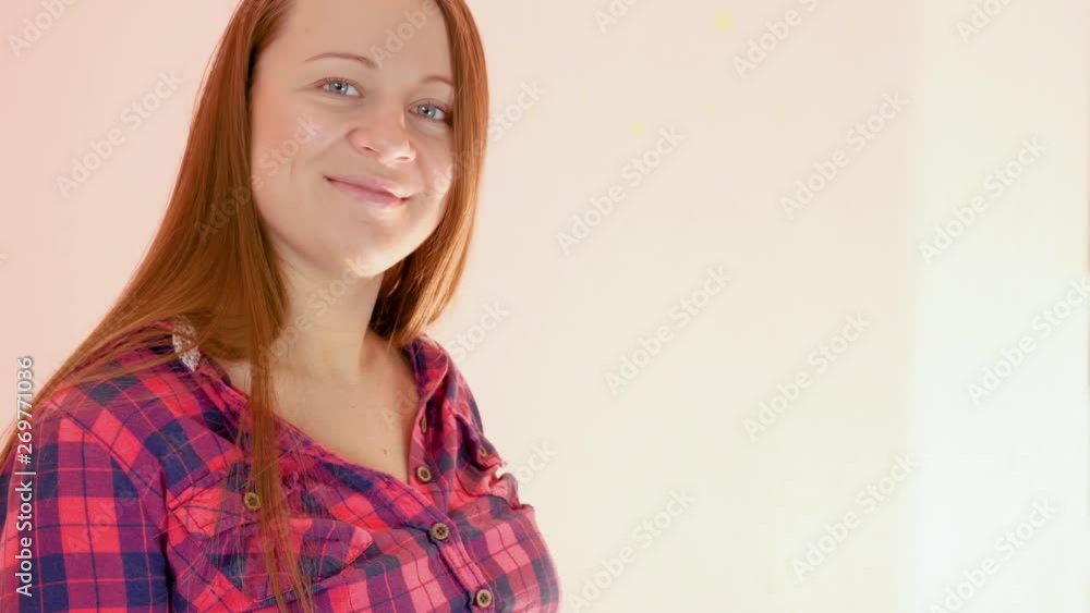 Happy Pregnant Woman Applying Belly Cream. Red shirt, light room. Close Up Shot Happy Pregnant Woman Applying Belly Cream. Red shirt, light room. Close Up Shot