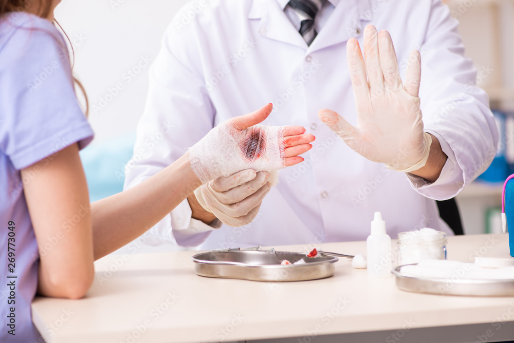 Hand injured woman visiting doctor traumatologist Hand injured woman visiting doctor traumatologist