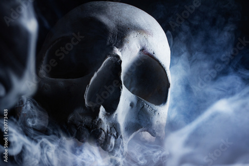 Human skull in smoke front view. photo