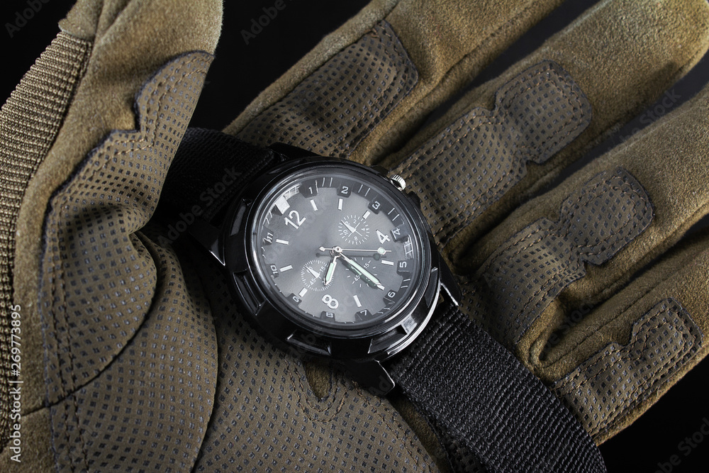 Soldier arm holding black tactical watch close up. foto de Stock | Adobe  Stock