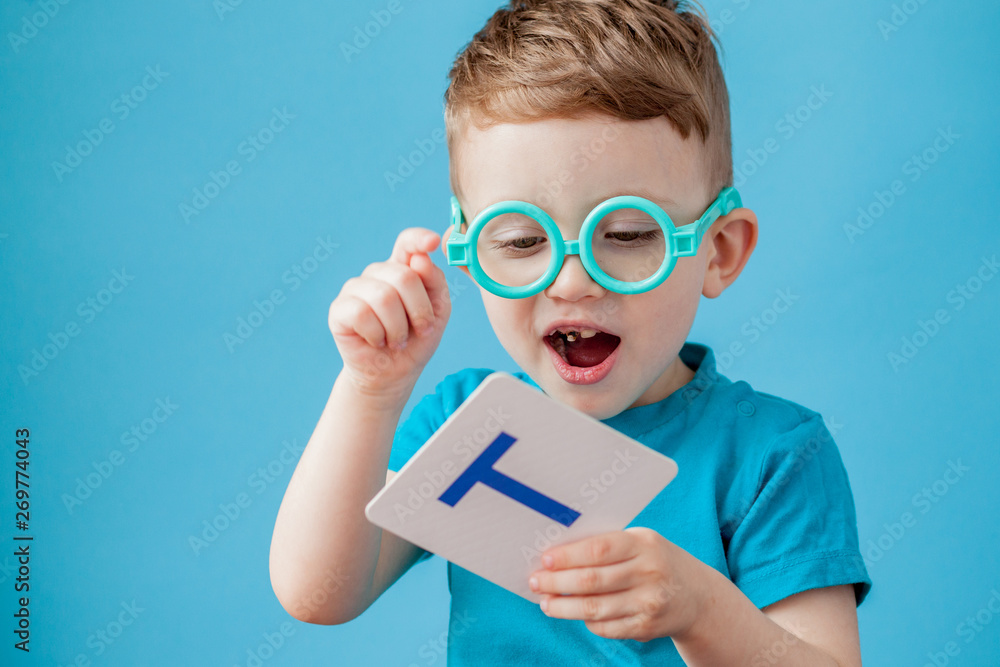 Cute little boy with letter on background. Child learn letters. Alphabet