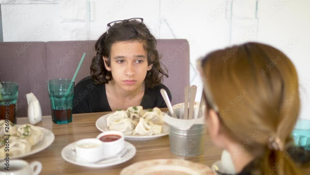 family eating khinkali in a restaurant family eating khinkali in a restaurant