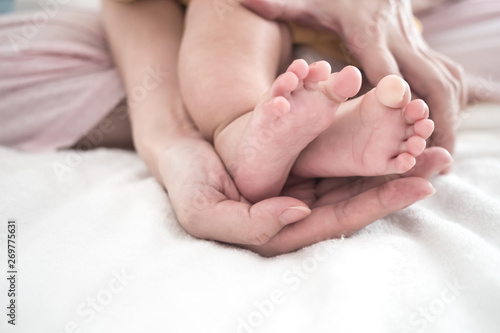 Mother hand hold baby foot: Concept of parent love