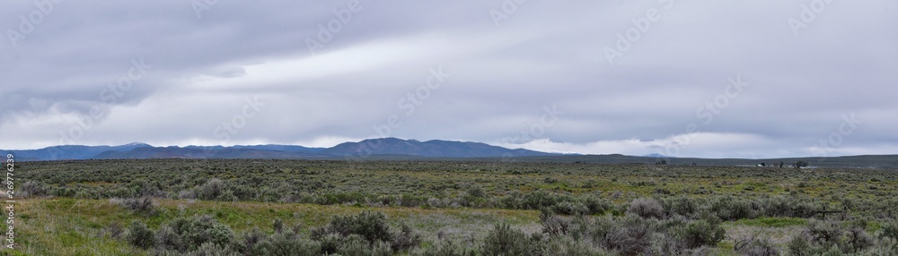 Sawtooth Mountains National Forest Landscape stormy panorama from South headed to Sun Valley, view of rural grazing land, Sagebrush, Lava Fields in Idaho. United States.