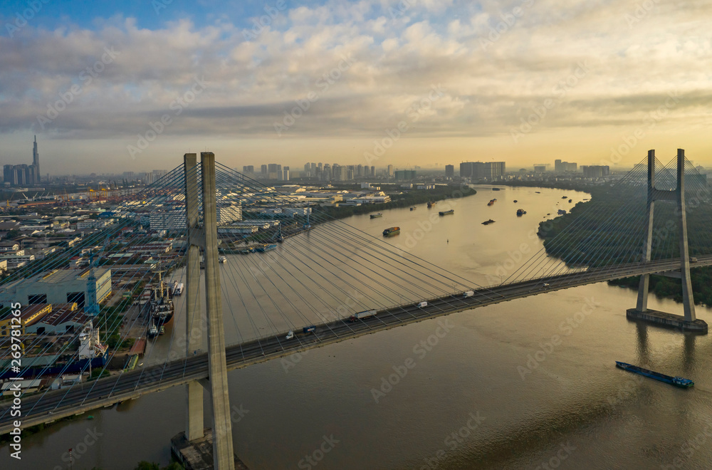 Shipping and Phu My Bridge at sunrise on the Saigon River, Ho Chi Minh City, Vietnam
